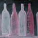 White and pink bottles on black background